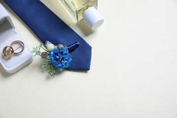 Wedding stuff. Composition with stylish boutonniere on light background, above view. Space for text