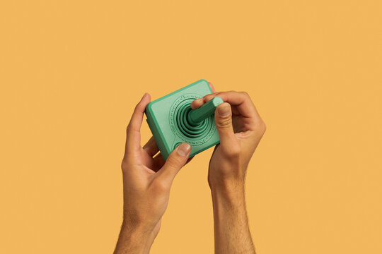 Hands holding gaming joystick controller 