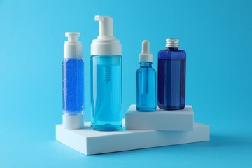 Set of luxury cosmetic products on light blue background