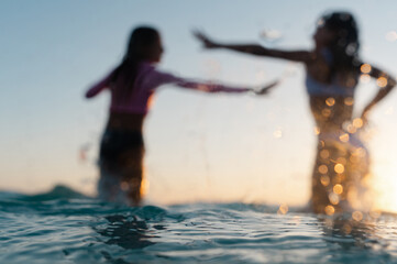 Anonymous kids playing at sunset