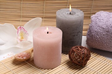 Composition with spa products, beautiful flower and burning candle on white table