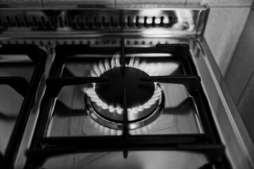kitchen gas stove alight with flame coming out of it. Conceptual photo for gas, cost of bills,...