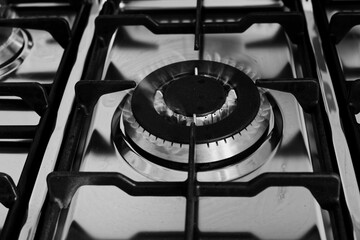 kitchen gas stove alight with flame coming out of it. Conceptual photo for gas, cost of bills, rising prices, heat and the environment. metal Ukraine, Russia, Europe. blu flame. united states. cook 