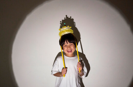 Asian little boy playing happily in spotlight light