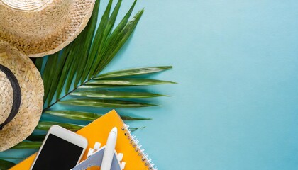 flat lay traveler accessories and tropical palm leaves on blue background with copy space travel summer and holiday concept