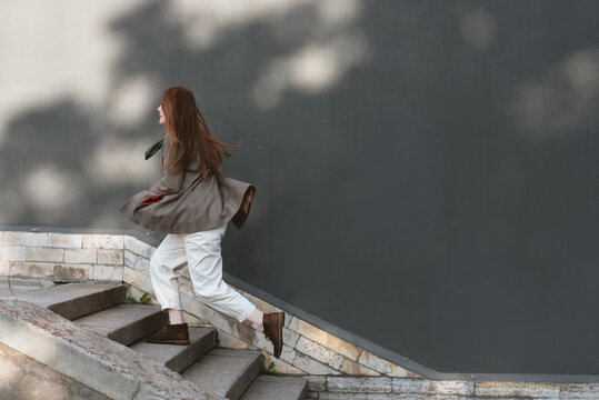 Woman running up the stairs