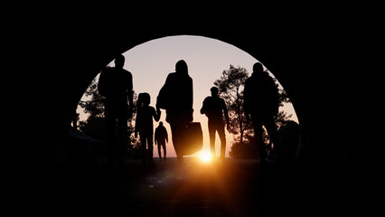 Refugees and immigrants looking for a new hope in life. Silhouette. Column of migrants passing through a tunnel. Abandon your lands for a better future. 3d rendering - 759101008