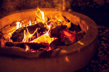 Burning flames of fire in a barbecue grill pit. BBQ place.