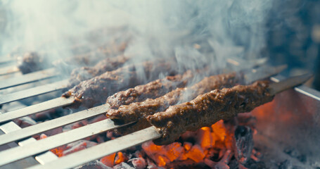 Cooking Adana kebab on the barbecue