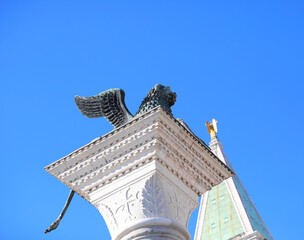 Winged lion symbol of Venice and the top of the bell tower of Saint Mark