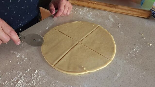 
Process of preparing ham and cheese croissants called "cachitos" in Venezuela