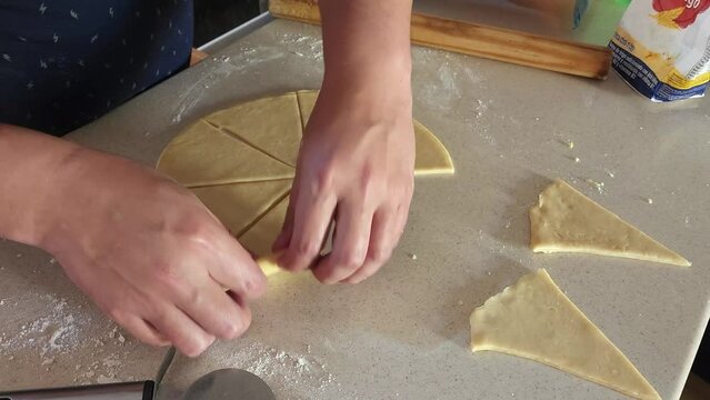 
Process of preparing ham and cheese croissants called "cachitos" in Venezuela