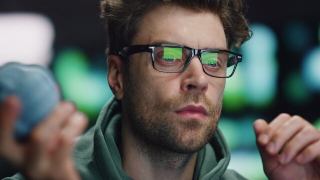 Serious computer scientist working in data center closeup. IT man holding ball