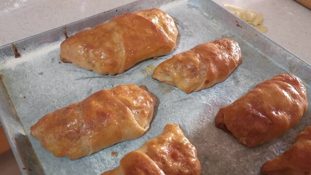 
Process of preparing ham and cheese croissants called "cachitos" in Venezuela