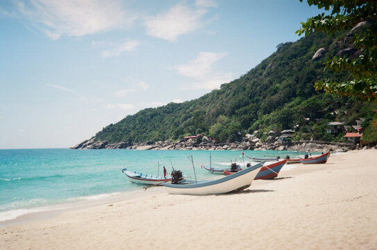 Boats on sandy beach on tropic paradise island. 