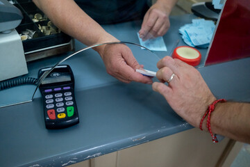 Man passanger buys paper tickets with Credit Card
