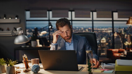 Serious boss checking phone sms late office interior closeup. Man typing laptop