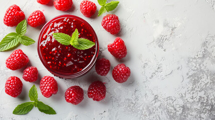 Raspberry jam accompanied by fresh berries set against a light backdrop