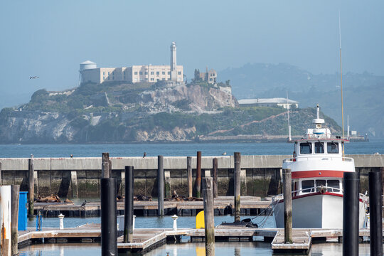 Boat on a pier of San Francisco with Alcatraz Island on the back 