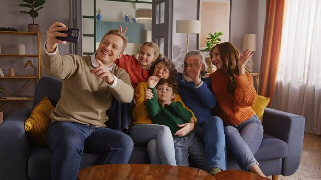 Family looking at smartphone screen and recording video