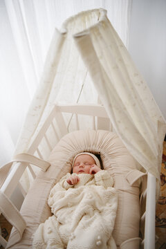 newborn baby sleeping in modern crib