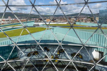 Beautiful glass dome-shaped observation deck at Victoria Square Shopping center with views of the entire city of Belfast and the Albert Memorial Clock, UK