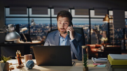 Happy business man consulting phone at evening office closeup. Boss ending call