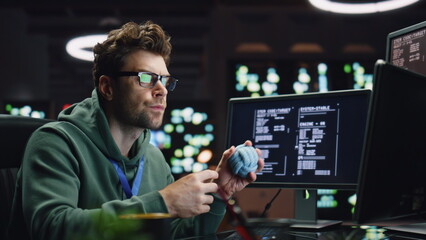 Pensive IT man working computer in late data center closeup. Coder guy creating