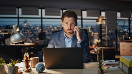 Confident boss calling phone evening view office closeup. Man talking smartphone