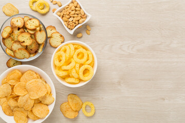 Different tasty snacks with sauce on wooden background, top view