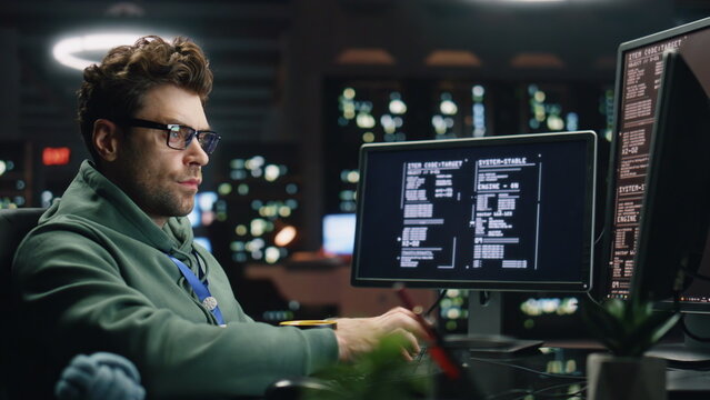 IT programer working keyboard desktop computer data center control room closeup