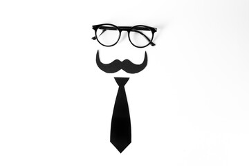 Fake mustache, tie and glasses on light background, top view
