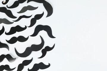 Fake paper mustaches on light background, flat lay. Space for text