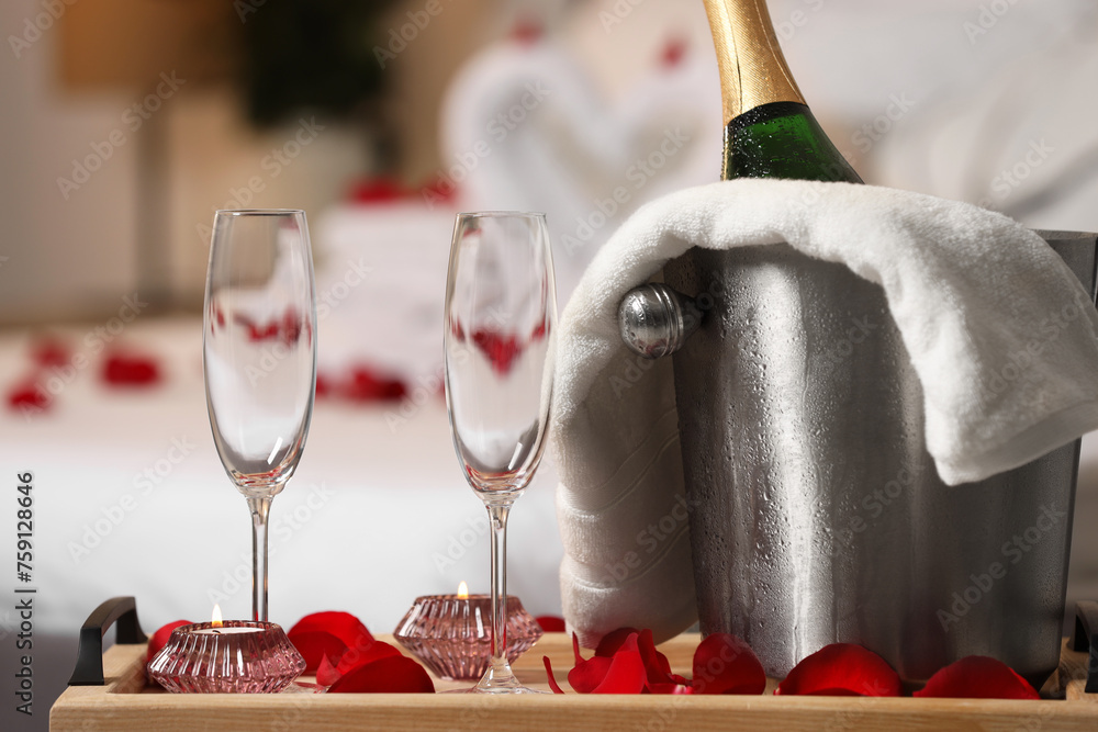 Wall mural honeymoon. sparkling wine and glasses on wooden table in room