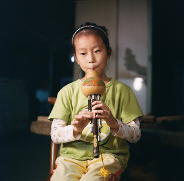 The girl is playing traditional Chinese instruments
