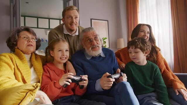 Big caucasian family finishing video game on sofa at daytime
