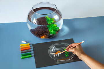 Soft pastel painting, drawing of gold fish in the bowl on the blue background. Set of soft pastel crayons	
