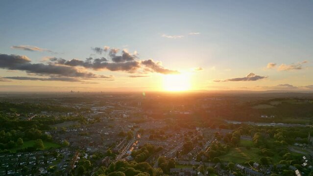 Stalybridge, Tameside, England with Manchester skyline in in the background. Dramatic red sunset