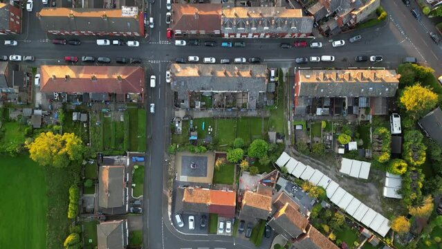 British houses, green gardens and parks from above filmed during golden hour sunset with 4K drone.