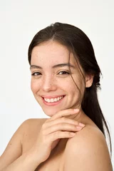 Poster Vertical portrait of happy Hispanic young woman with freckles on face isolated on white background. Beauty aesthetic shot of smiling pretty Latin girl model looking at camera advertising skin care. © insta_photos