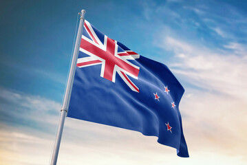 Fototapeta premium Waving flag of New Zealand in blue sky. New Zealand flag for independence day. The symbol of the state on wavy fabric.