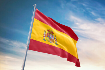 Waving flag of Spain in blue sky. Spain flag for independence day. The symbol of the state on wavy fabric.