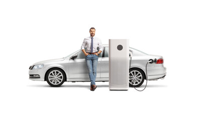 Man with a silver car at EV charging point