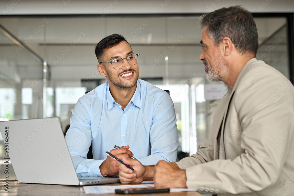 Aufkleber young smiling professional latin business man working in corporate office with older executive manag