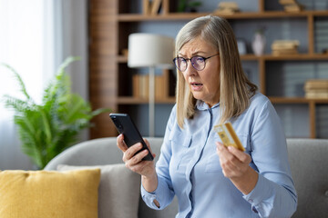 An older woman looks confused while holding a credit card and looking at her smartphone, possibly dealing with online shopping or technology challenges.