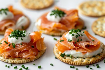 salmon and crackers with sour cream and chives against a white backdrop