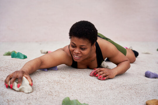 Female Climber Descending Artificial Wall