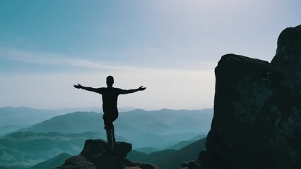 A tourist on top of a mountain, raising his hands, rejoices at the wonderful view. You are free and feel freedom, inspiration to create new achievements. The whole world is in your hands