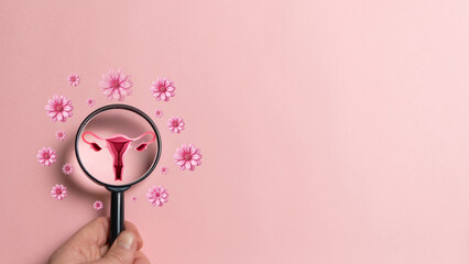 Female fertility concept, magnifying glass with ovary and flowers representing fertility.
