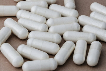 A stack of supplement capsules, dietary supplements, vitamin tablet, nutritional supplements in capsule form.